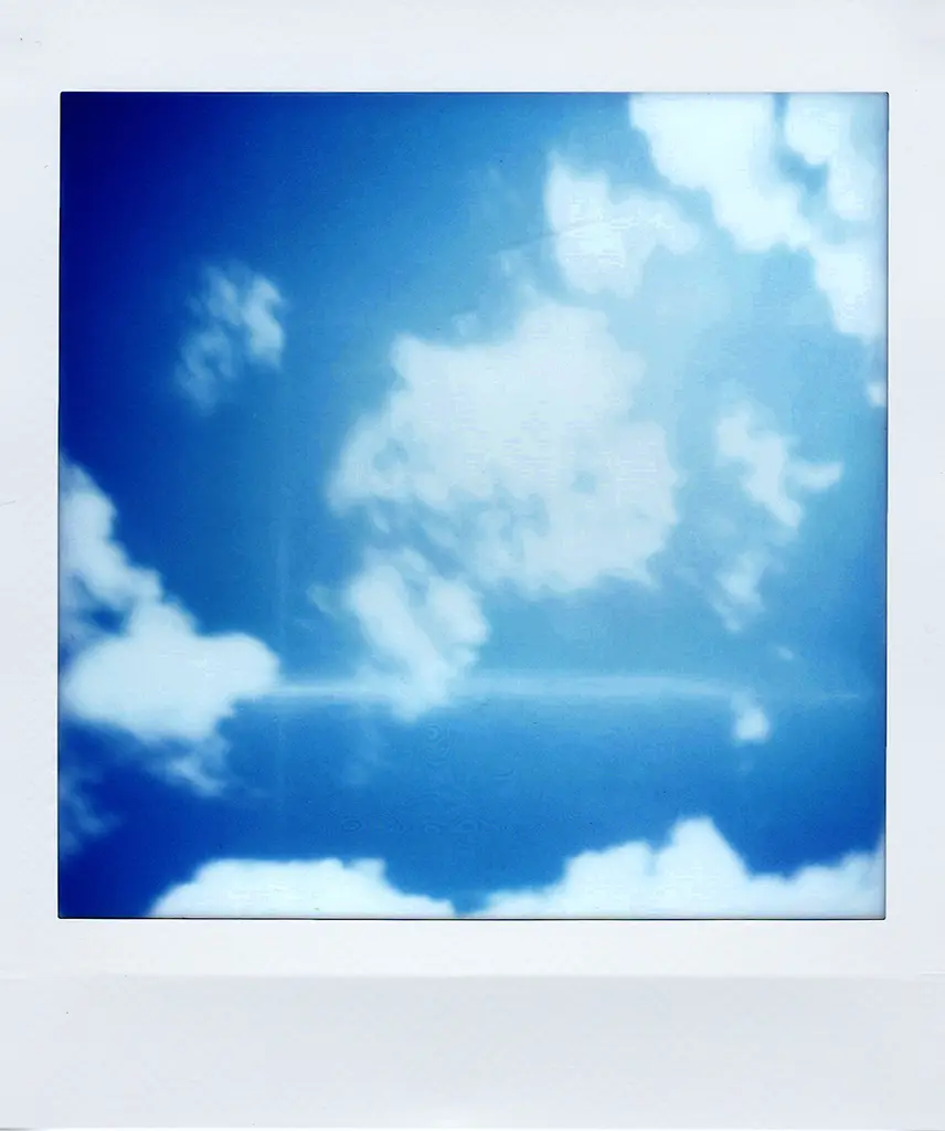 Polaroid avec un ciel bleu et des nuages